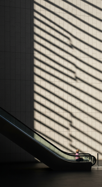 Minimalist Indoor Architecture Photo of Woman on Escalator with Sun Stripe Shadows - Free mobile Wallpaper