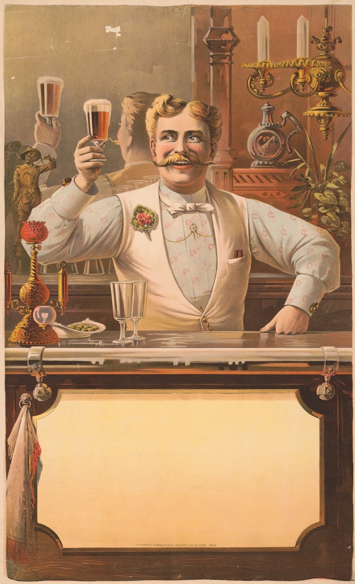 Bartender standing behind a bar holding up a glass of beer in his right hand 188