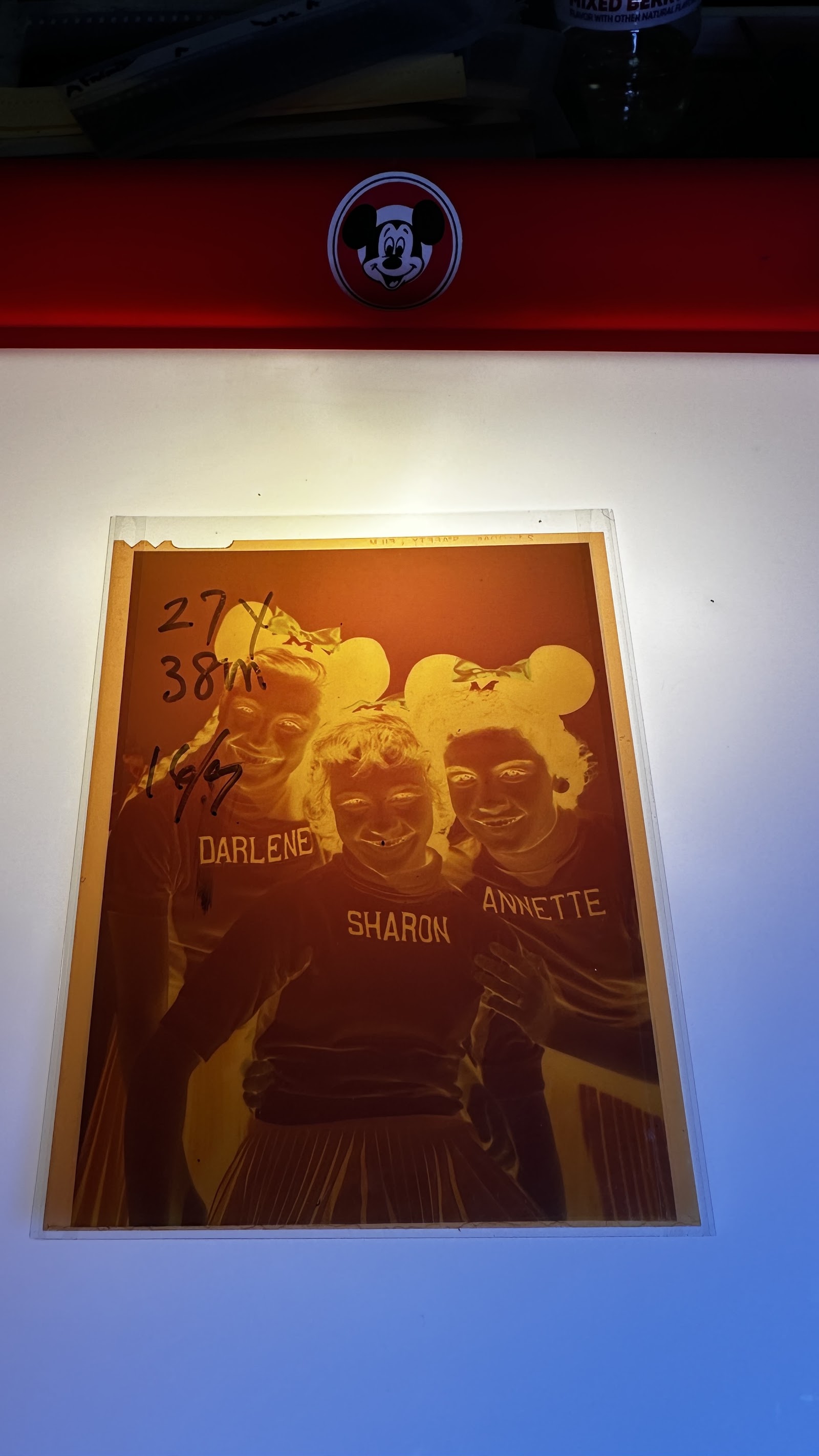 Large-format acetate production negative showing Mouseketeers Annette Funicello, Darlene Gillespie, and Sharon Baird in personalized sweaters and mouse-ear hats, with handwritten studio crop annotations visible