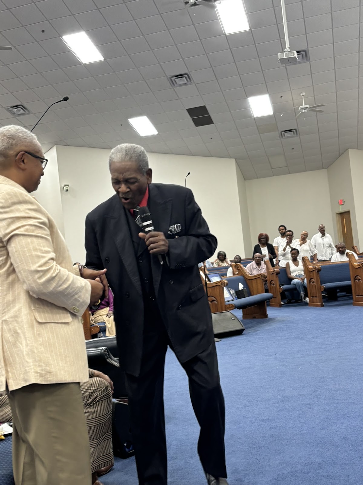 Two church leaders sharing a handshake during Homecoming 2026 at Sharpe Road Church of Christ