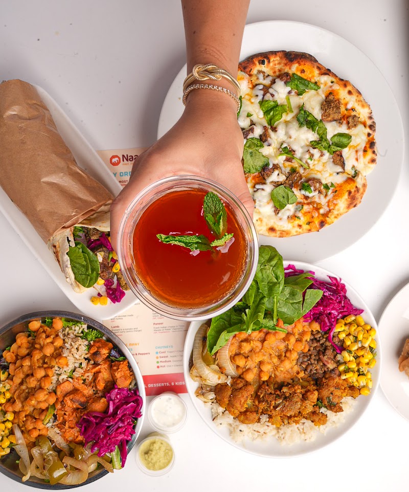 NaanStop food spread with fresh butter naan, curries, rice bowls & chutneys