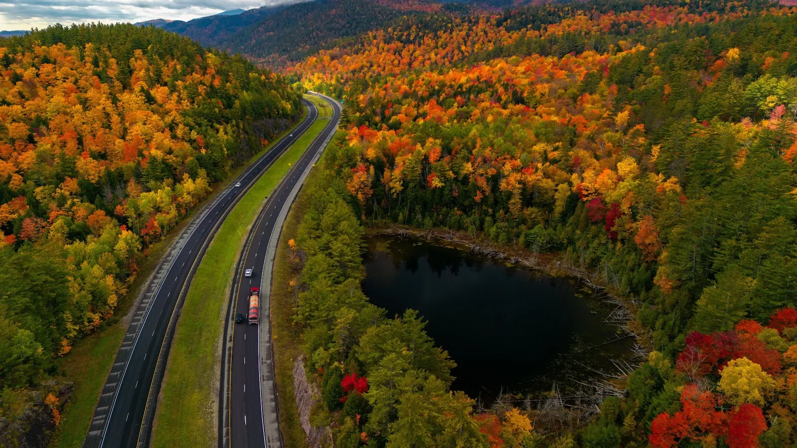 Winding Highway Through Autumn Forest - Aerial Landscape Photography 5K Wallpaper (5120x2880)