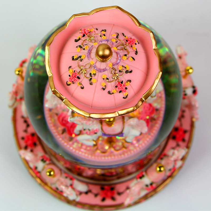 Decorative music box with snow globe and carousel