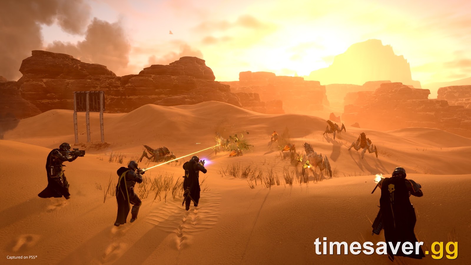 A full Helldivers 2 squad firing on a Terminid swarm across a desert after a clean, stable launch