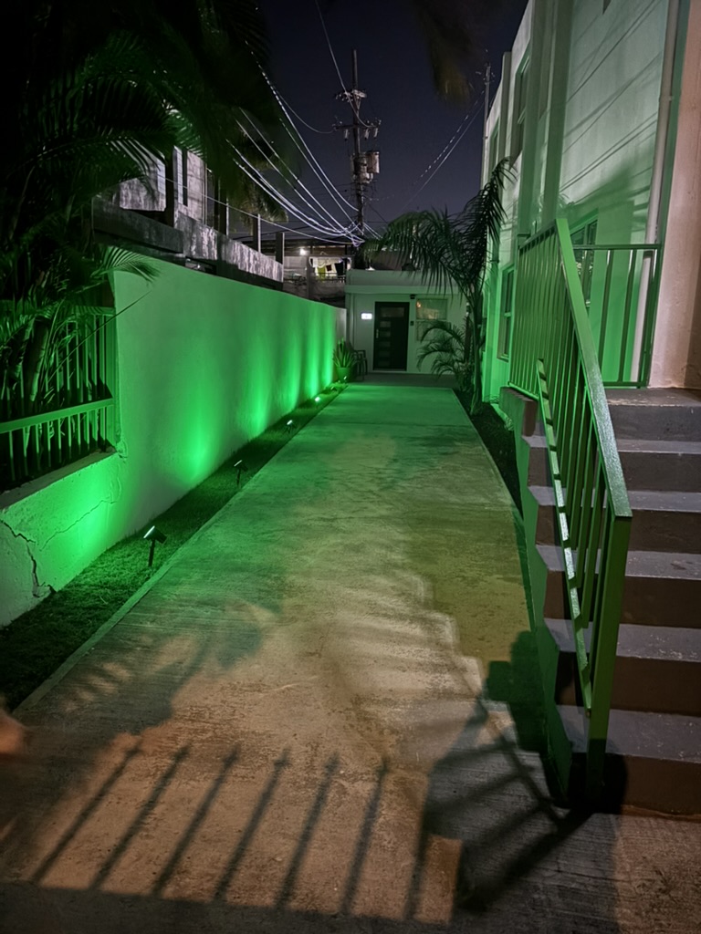 Walkway to the back apartments, lit up in the evening