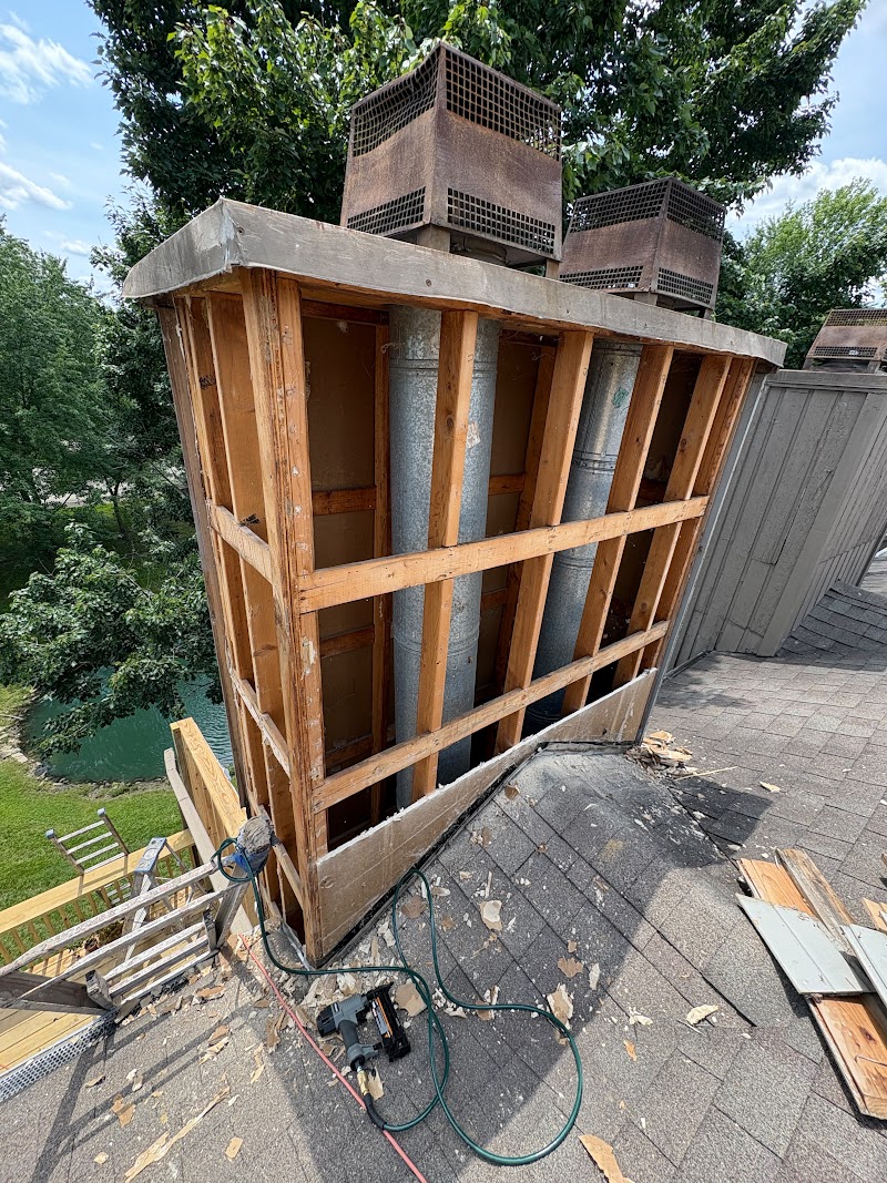 Chimney chase at The Lookout stripped to the framing with flues exposed during sheathing replacement