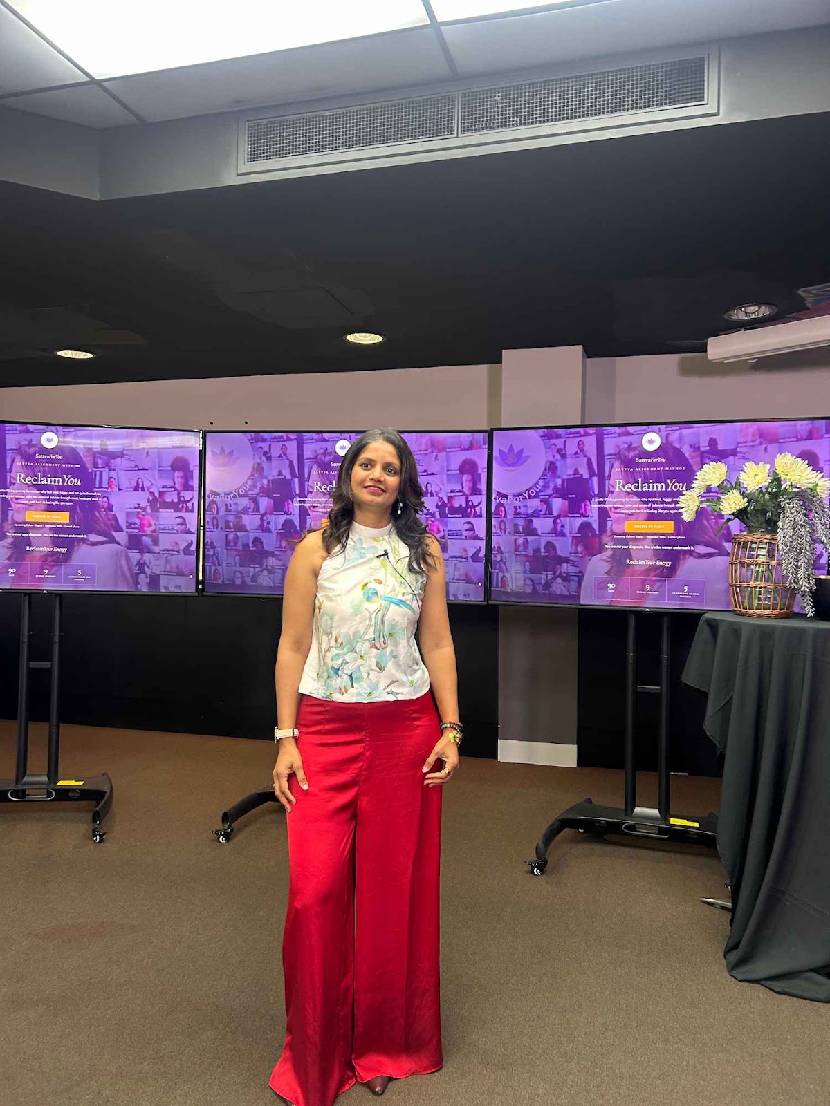 Preethi B Bellarry warmly addressing the audience and sharing transformational wellbeing insights on stage