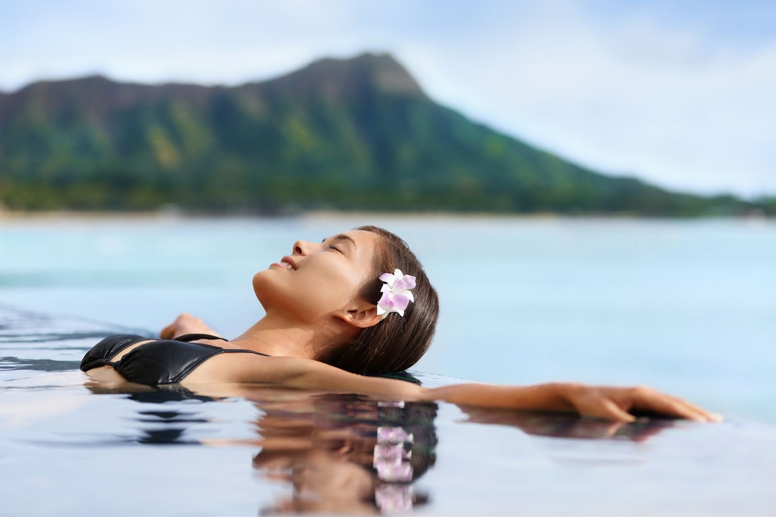 Woman relaxing in pool Hawaii