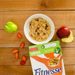 Rửa sạch và cắt nhỏ vừa ăn các loại tái cây. Cho 1 lớp ngũ cốc Nestlé FITNESSE vào tô