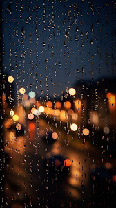Raindrops on Window with Blurred City Lights