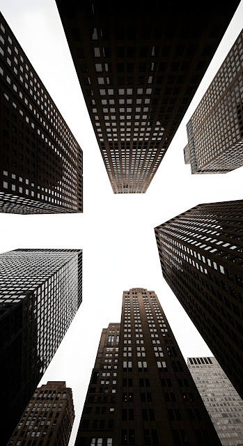 Extreme Low Angle Looking Up at a Cluster of Converging Skyscraper Facades Against Sky - Free mobile Wallpaper
