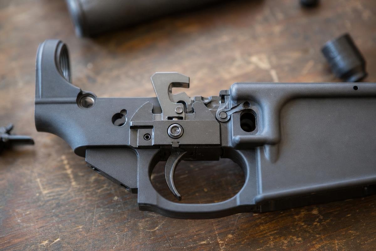 AR-15 drop-in trigger group showing trigger pull weight adjustment components