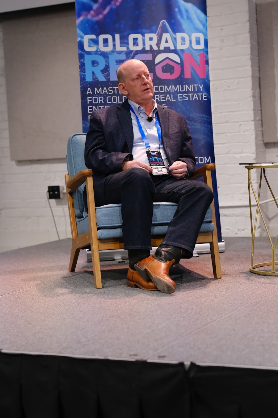 Speaker on stage at a past Colorado RE•CON event