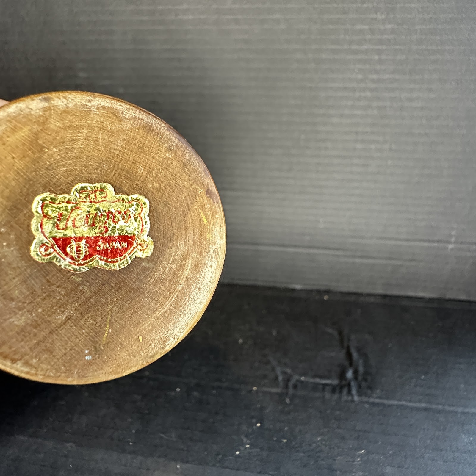 Circular vintage wooden figurine base with gold foil Walt Disney Productions and Japan label, 1970s, light wood stain finish