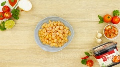 Lấy 200gr kim chi Bibigo ra khỏi hộp, đem cắt nhỏ (có thể vắt cho ráo bớt nước). 200gr thịt ức gà đem cắt thành những miếng hạt lựu vừa ăn. 100gr dưa leo, 100gr cà chua và 50gr hành tây đem cắt tất cả thành những miếng hạt lựu.