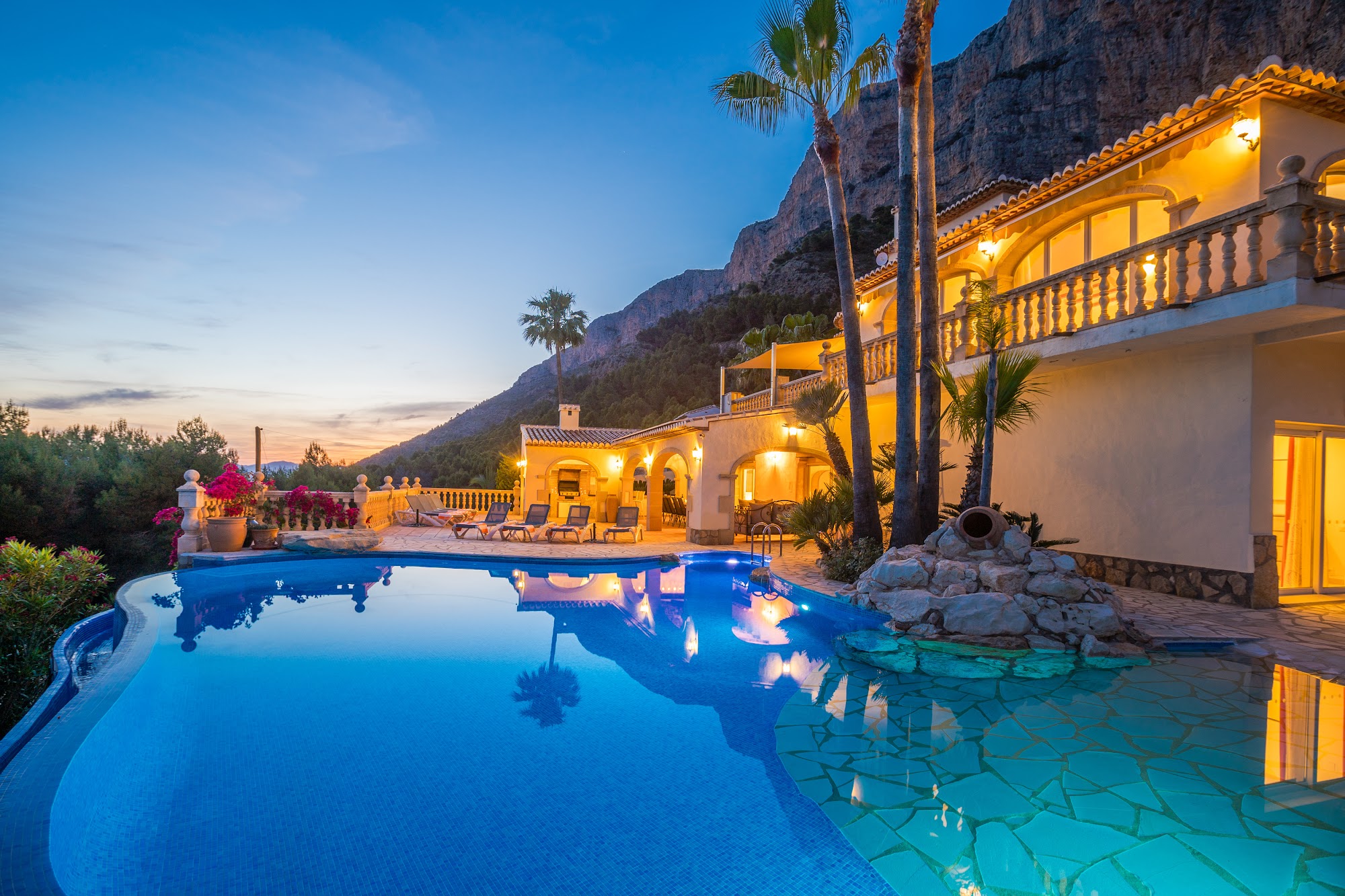 Villa exterior at dusk with pool