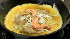 Đun nóng chảo gang, cho 1 muỗng canh dầu ăn vào phết đều chảo. Đổ 1 vá bột tráng đều chảo, thêm nhân tôm thịt, nấm rơm và giá đỗ. Đậy nắp trong 1 phút. Sau đó, đánh tan trứng vịt đổ vào rìa bánh. Tiếp tục, đổ thêm 2 muỗng canh dầu ăn vào mép bánh để bánh được giòn ngon. Chiên bánh thêm 2 phút nữa thì lấy bánh ra hoặc gập bánh lại.