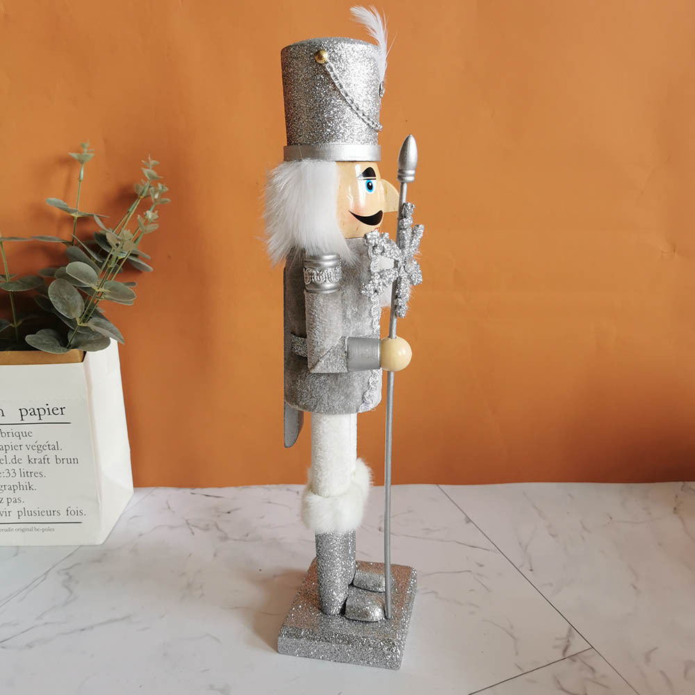 Decorative wooden nutcracker figure with snowflake design