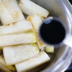 Đun nóng 1 muỗng canh dầu ăn trong nồi, cho củ cải cho chiên cháy xém các mặt. Sau đó đổ nước dùng (nấu từ cá cơm và rong biển) vào, thêm đường vàng, nước tương, nước màu, tỏi băm vào, đun sôi cho củ cải gần chín và ngấm đều sốt khoảng 10 phút. Cuối cùng thêm bạch tuộc và ít dầu mè vào, đun tiếp 5 phút.