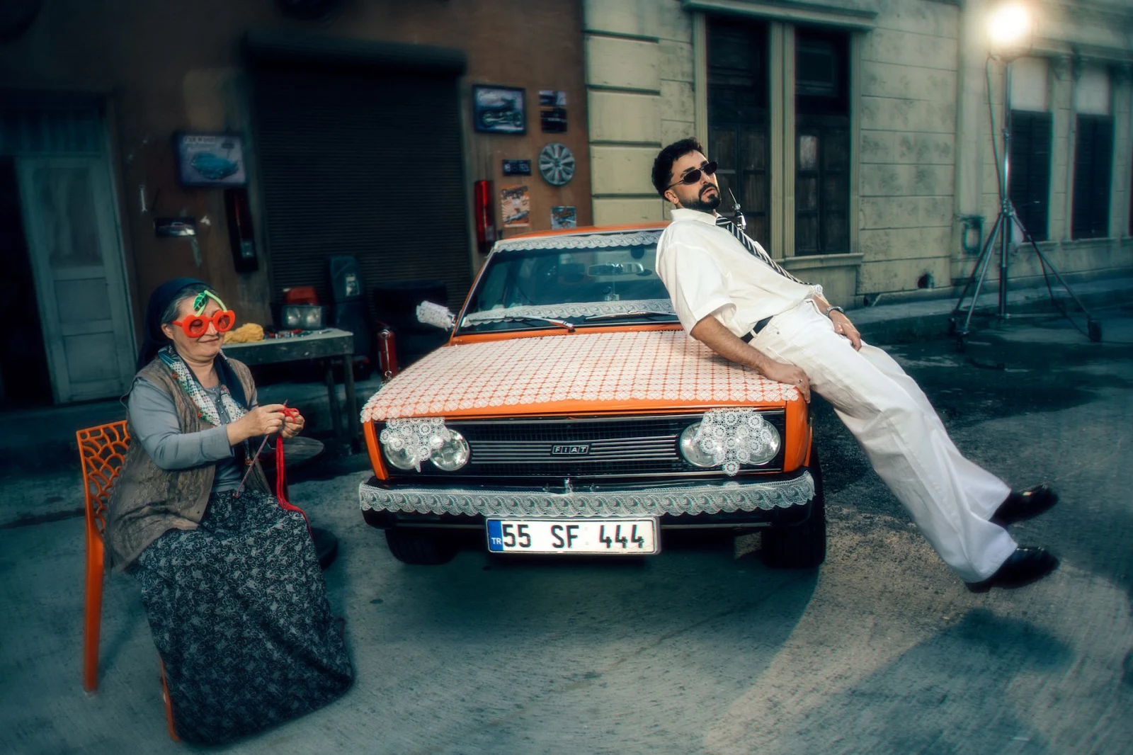 A humorous street scene with a vintage car and two unique, quirky characters.