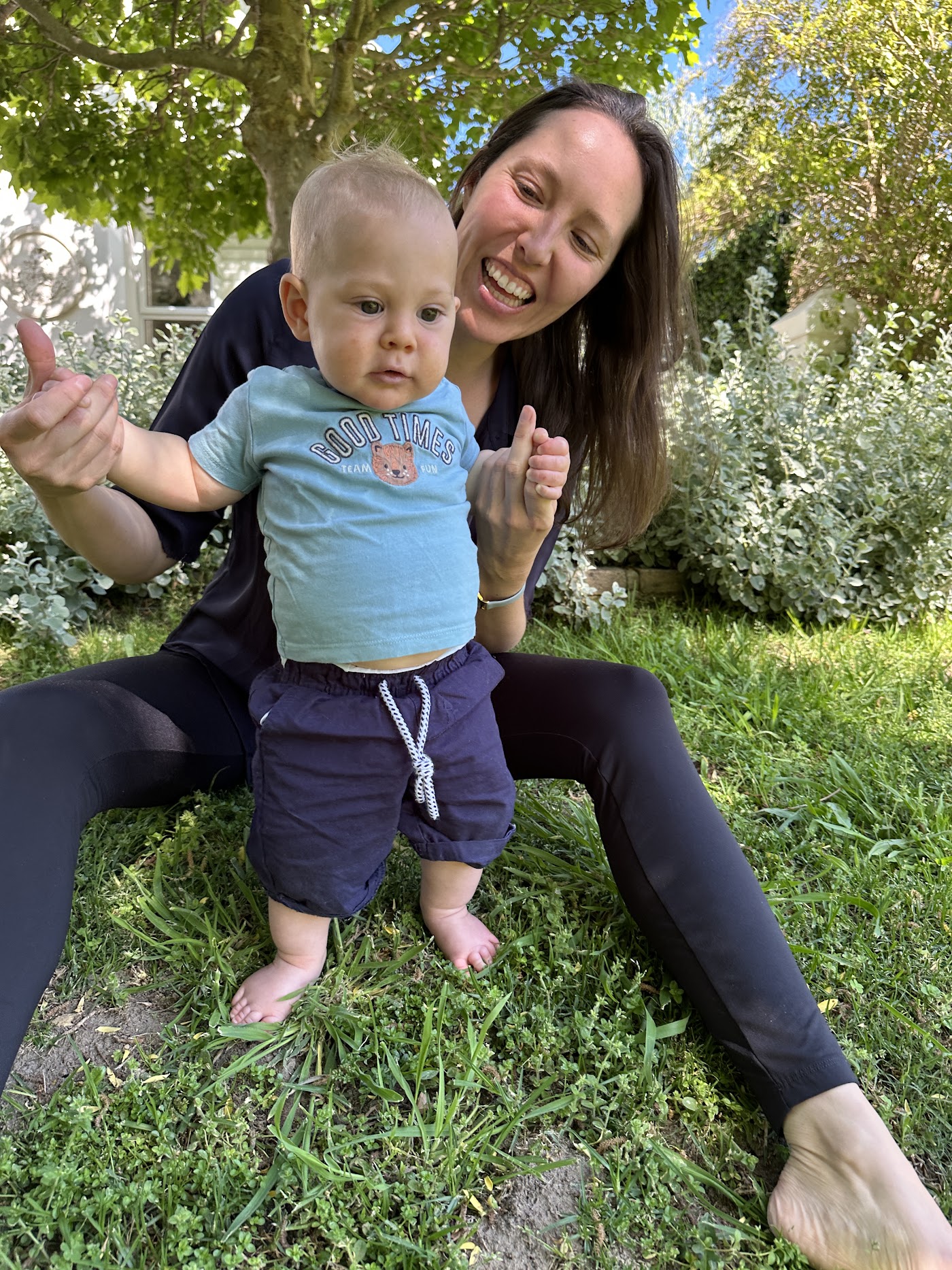 Savannah, paediatric feeding therapist and lactation consultant, with her son in the garden