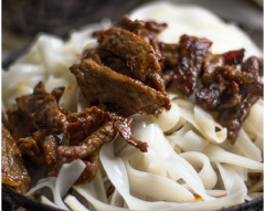 Thịt bò đã xào xong, bạn cho ra ngoài để riêng rồi thả hành tây vào xào trong khoảng 1 phút, kế đó, cho giá đỗ vào xào 30 giây nữa. Cho bánh phở vào xào. Thả phần thịt bò cùng 1/2 bát nước sốt trở lại, đảo đều cho nước sốt thấm vào bánh phở cùng rau củ, cho hành lá vào, đảo đều lần nữa rồi tắt bếp.