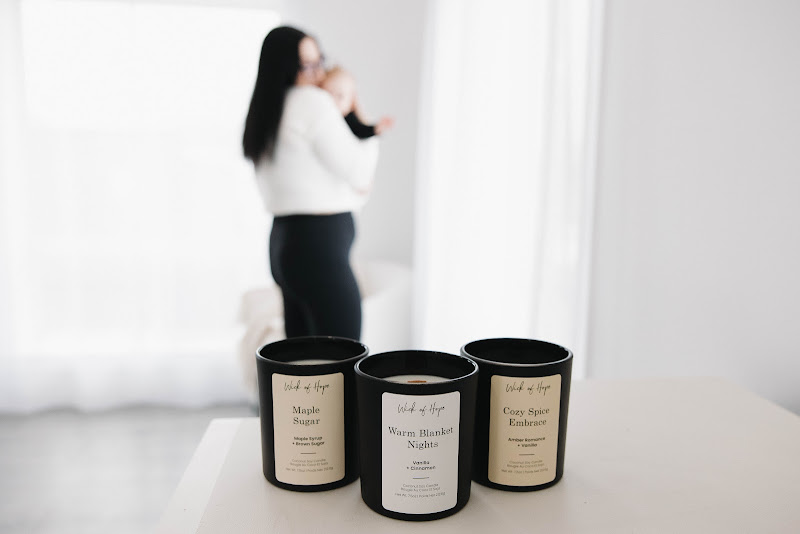 Woman relaxing in a cozy sweater with coffee and candle