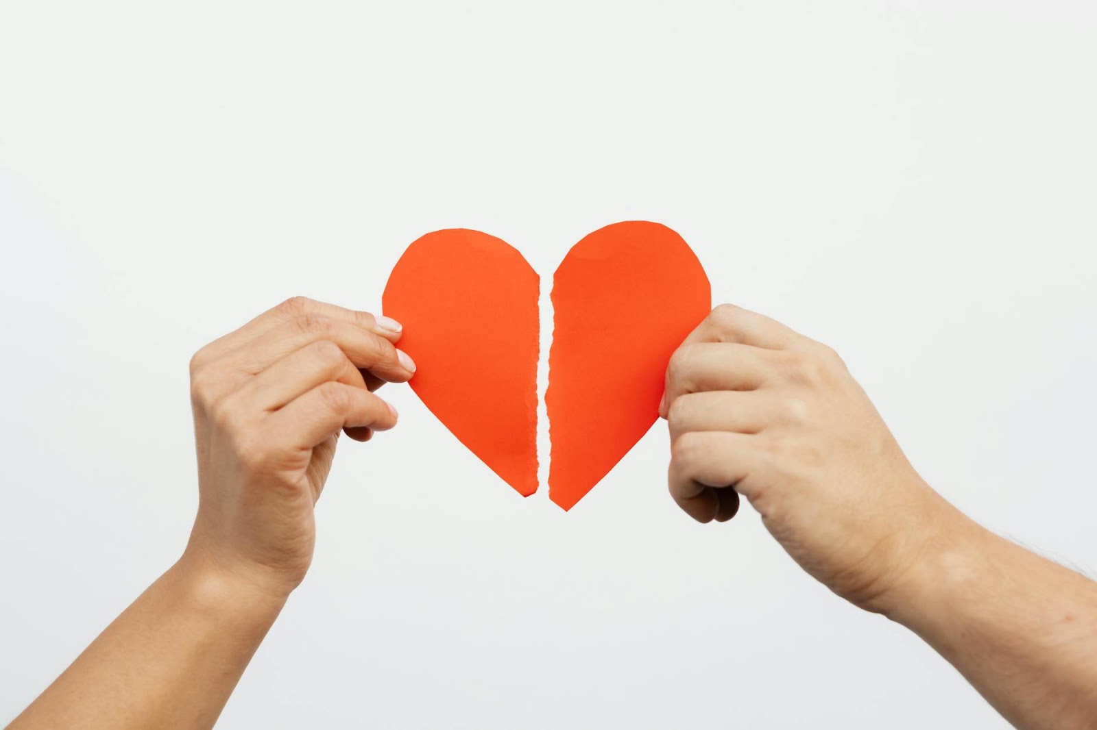 A surreal image of a robot hand delicately holding a human heart, symbolizing the complex and sometimes unsettling relationship between AI dating apps and genuine human emotion.
