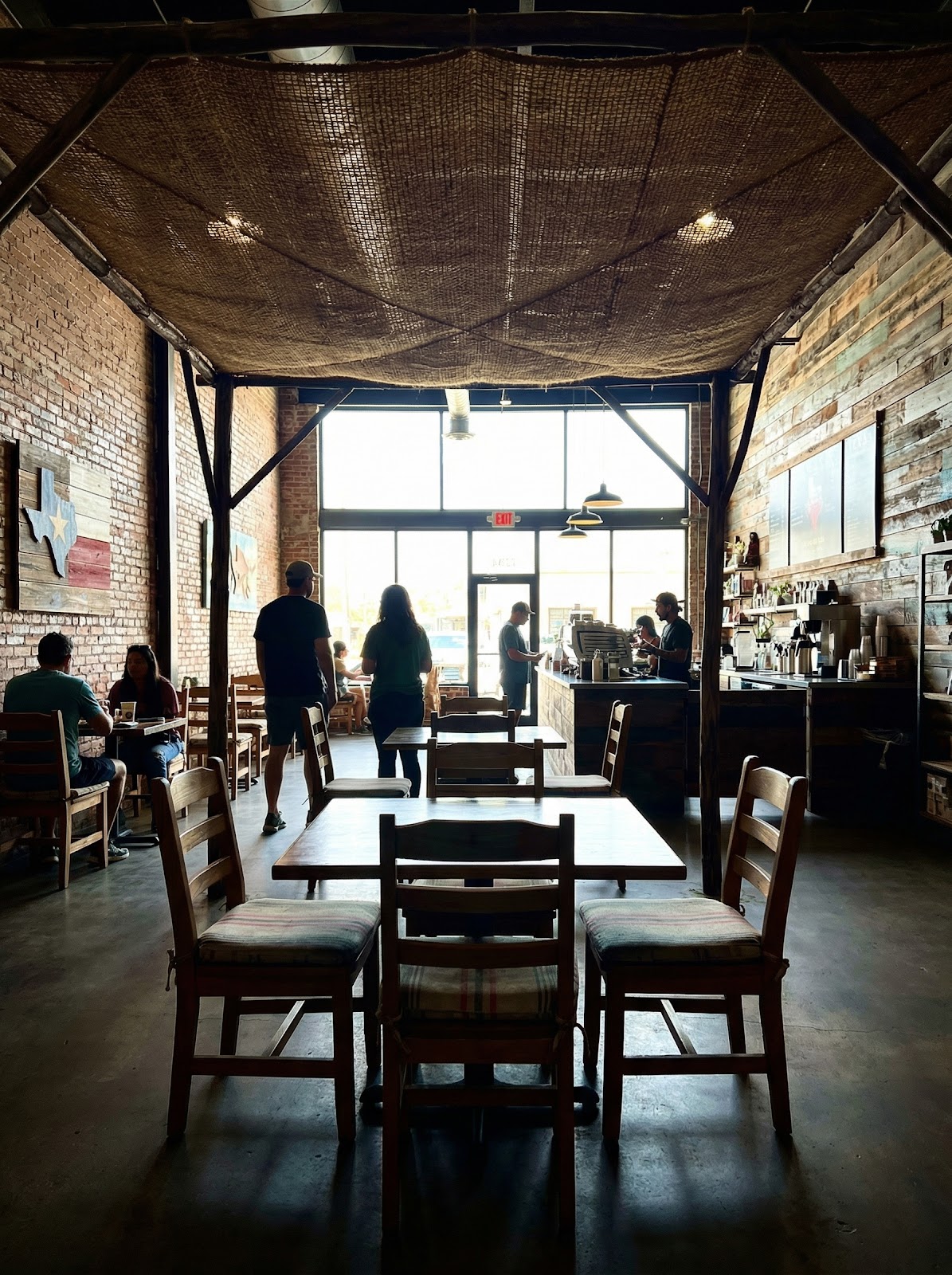 Commercial cafe interior with natural coir shade canopy and warm ambience