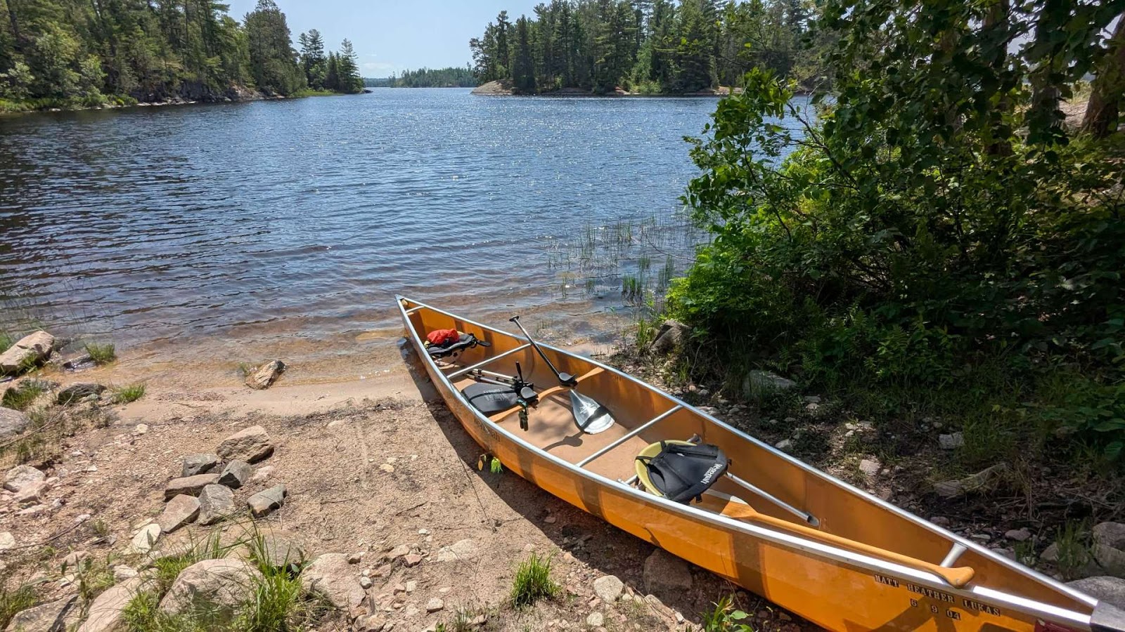 Canoe on a calm river shore