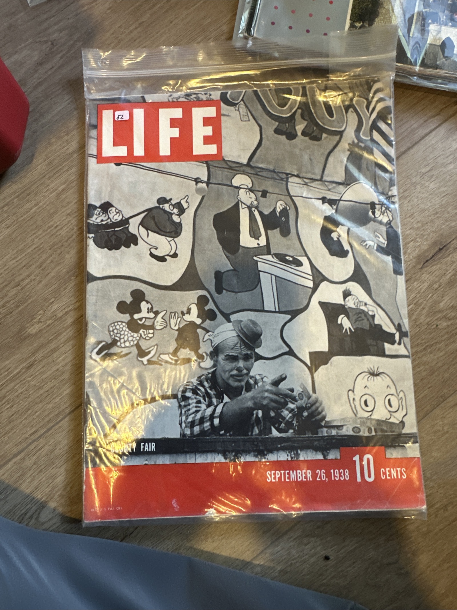September 26, 1938 LIFE magazine, 14 by 10.5 inches, with vibrant red masthead, showing County Fair mural featuring Mickey and Minnie Mouse artwork, stored in protective plastic sleeve