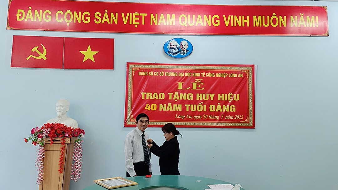 Đồng chí Lê Thị Kim Yến – Bí thư Đảng ủy trường trao huy hiệu 40 năm tuổi đảng cho đồng chí Huỳnh Văn Xê