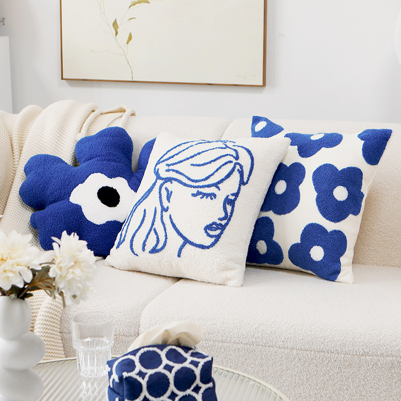 Cushion cover with embroidered daisy motif