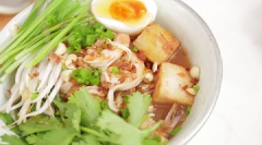 Gắp mì ra bát, thêm giá đỗ, hẹ, trứng, vài miếng đậu và tôm. Trên cùng xếp rau mùi, rắc đậu phộng rang, hành phi và rưới chút dầu mè.