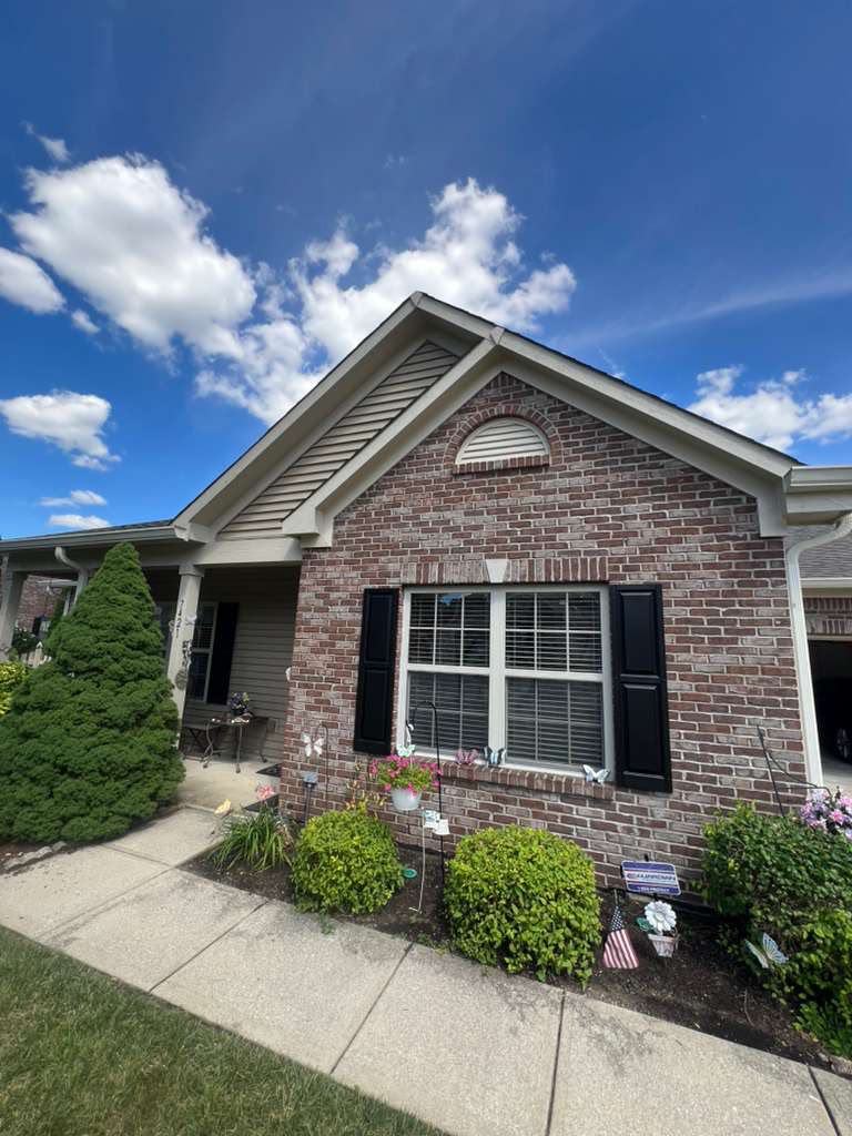Brick gable end at Seneca Pointe with repainted shutters, white trim and arched gable accent
