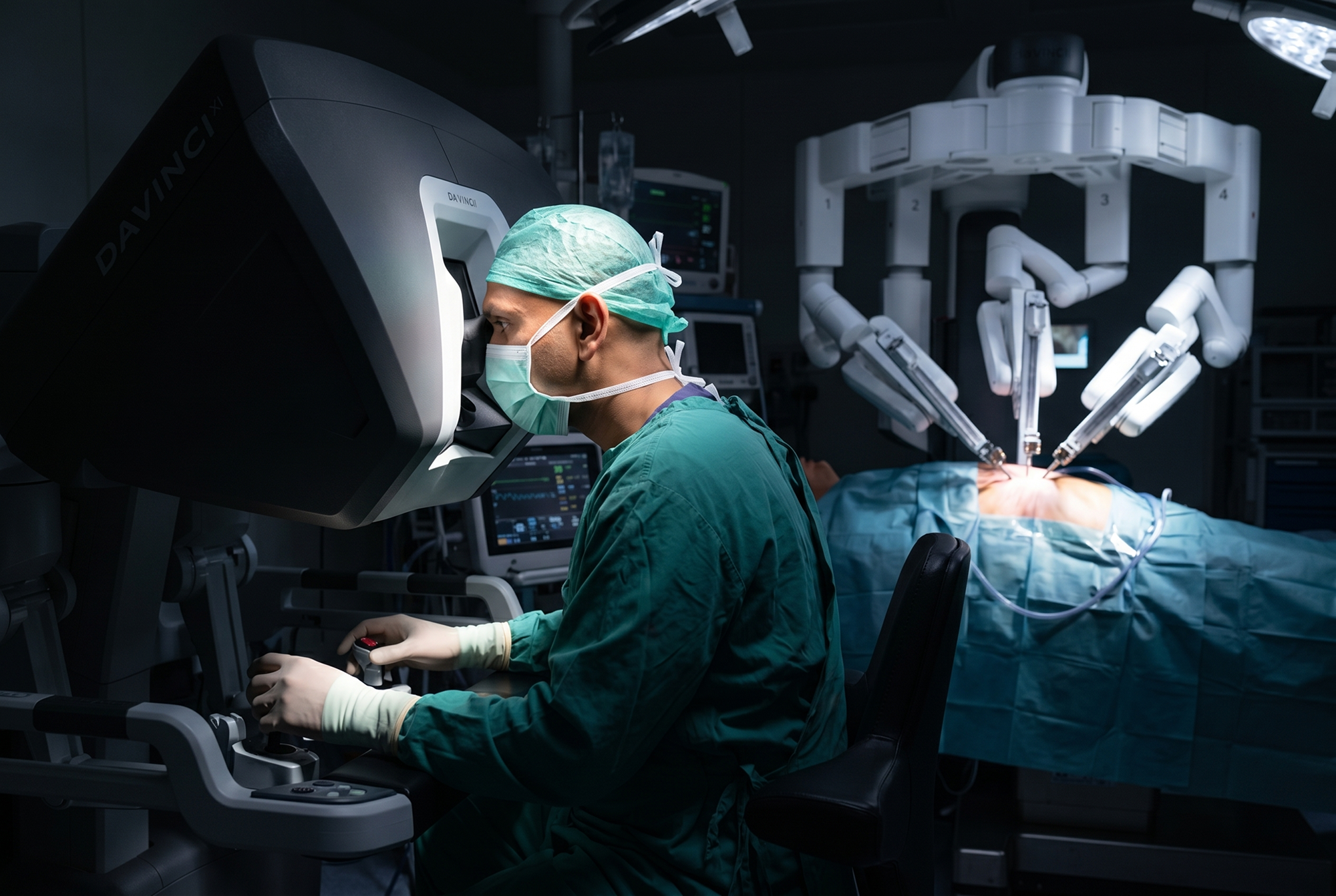 da Vinci robotic arms inside sterile operating room representing robotic surgery