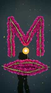 Magenta Flower Letter M and Glowing Diya on Dark Water