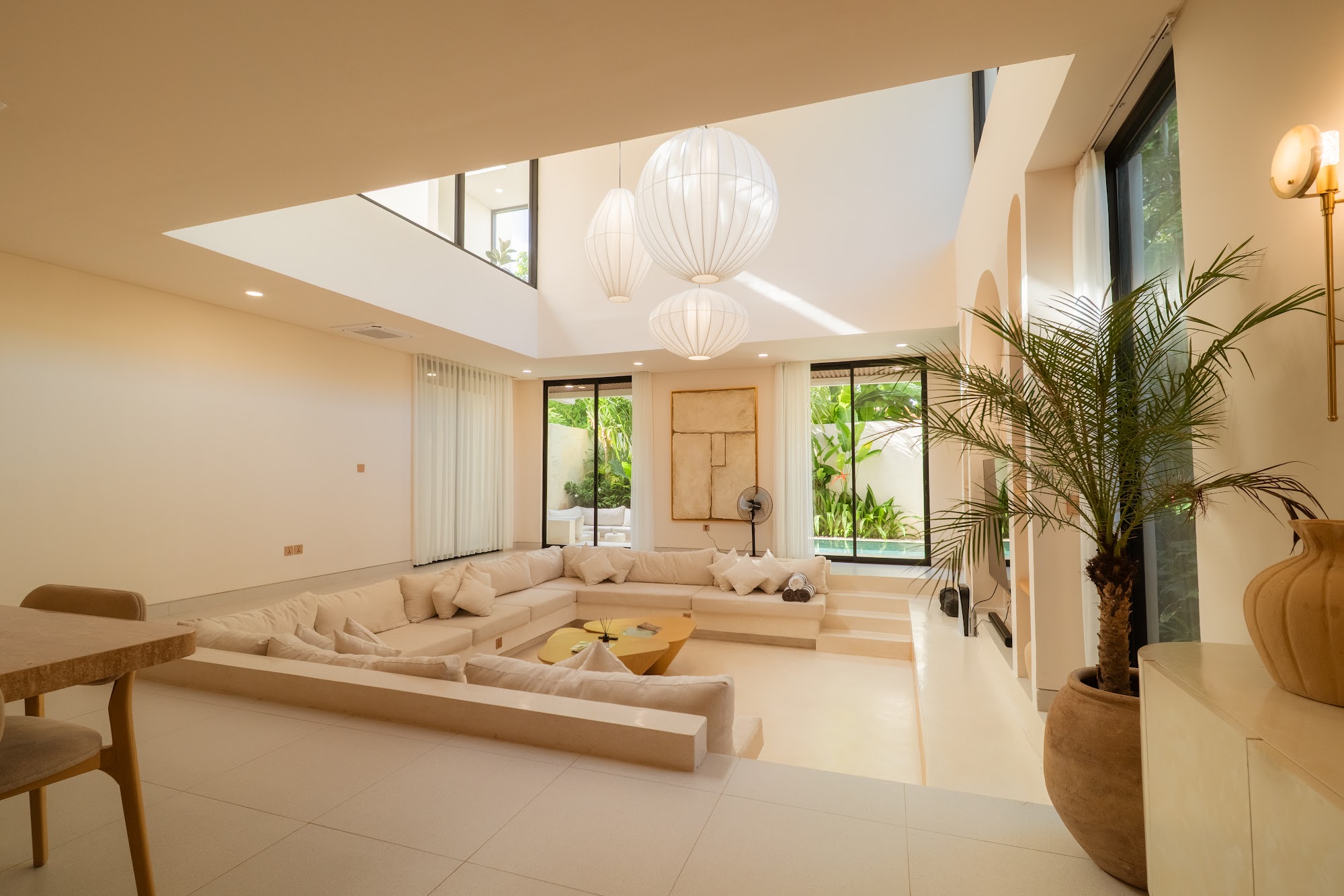 Seven metre sunken living room with paper pendant lights at La Calma villa in Uluwatu, Bali