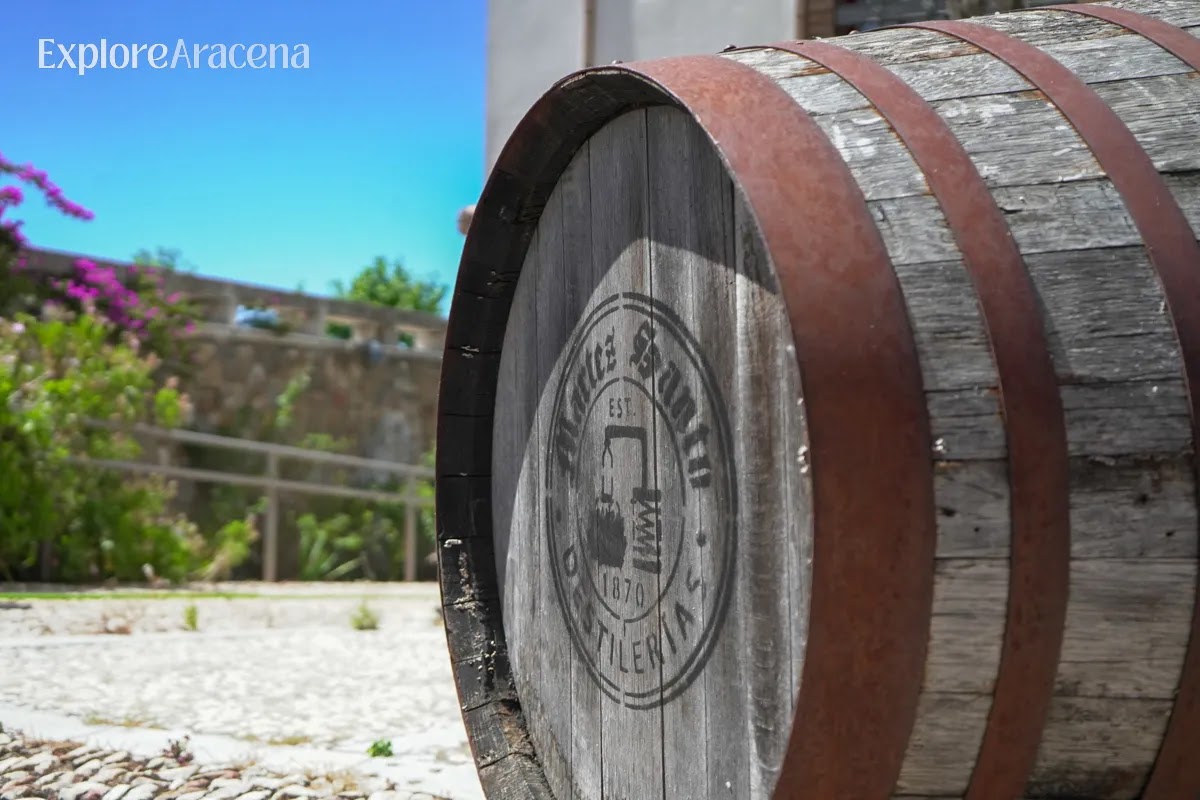 Close-up of a wooden barrel with the Martes Santo branding outside the historic distillery near Aracena.