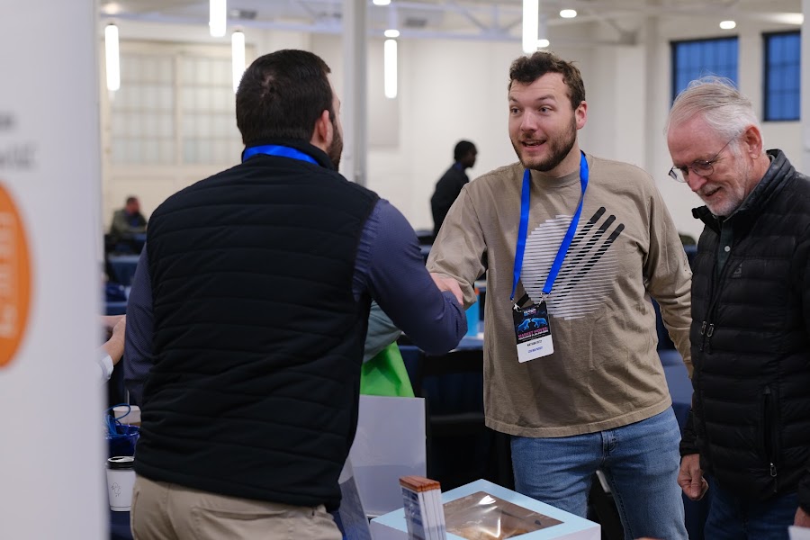 Two attendees in conversation at Colorado RE•CON