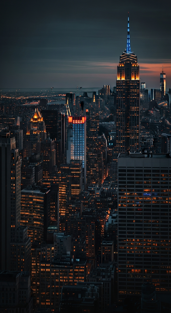 High Angle Night View of Midtown Manhattan Skyline with Illuminated Neon Signs and City Lights