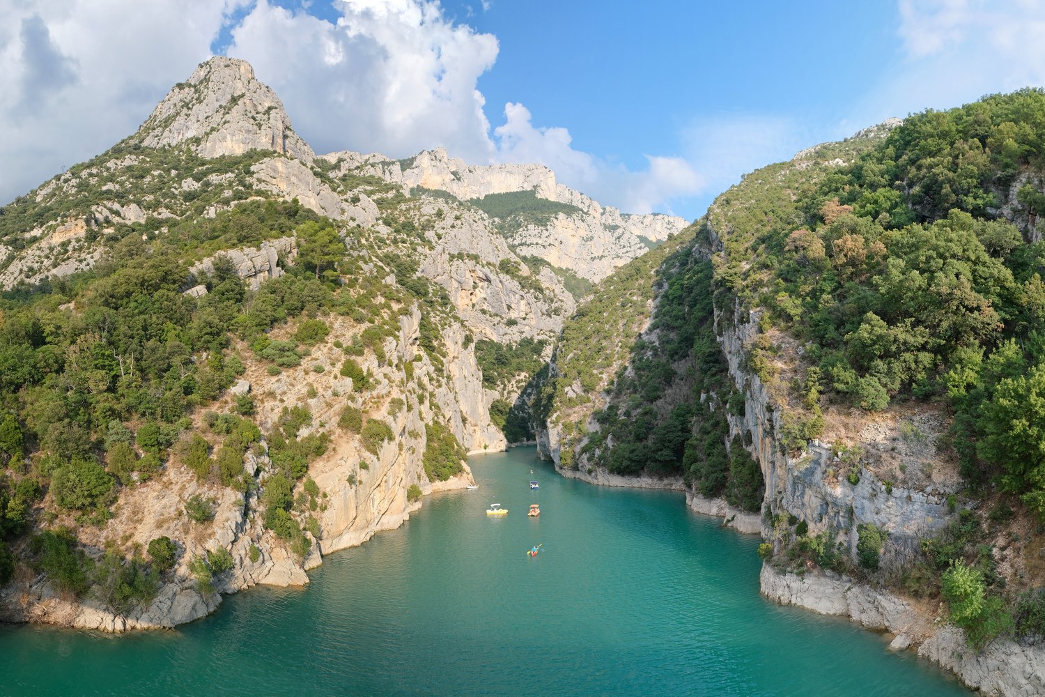 Limestone canyon walls of the Gorges du Verdon meeting the turquoise waters near Lake Sainte-Croix