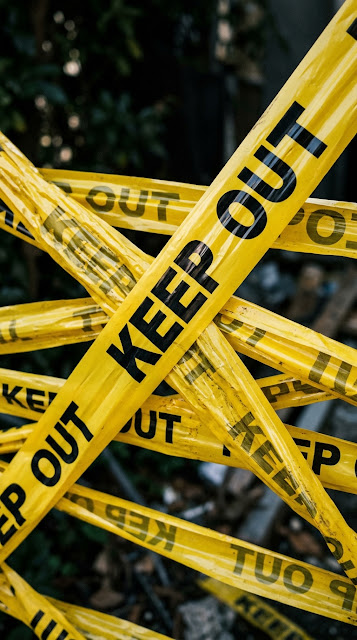 Layered Yellow Keep Out Caution Tape against a Dark Background - Free mobile Wallpaper