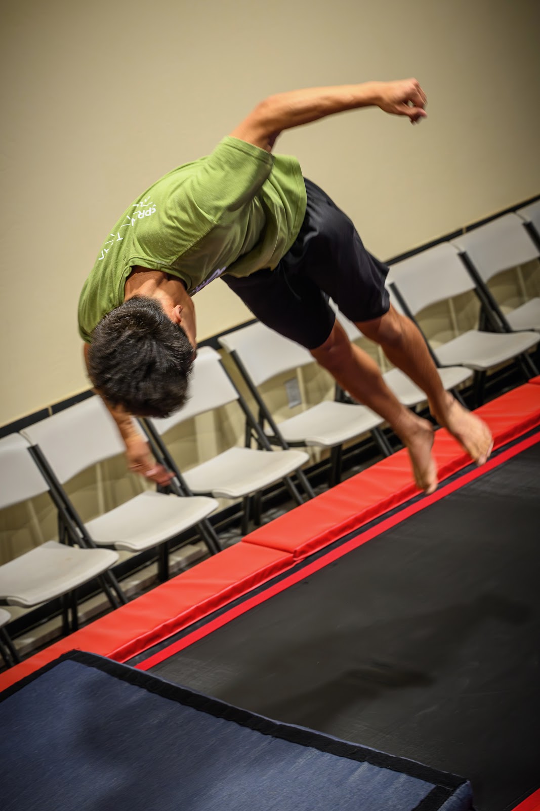 Student mid-backflip on trampoline