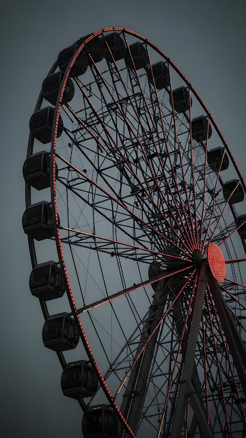 Moody Ferris Wheel with Red Lights Against Dark Sky - Free mobile Wallpaper