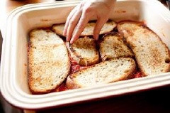 Cho một ít nước sốt cà chua vào khuôn rồi xếp bánh mì lên trên. Dùng sốt cà chua không hay có thêm thịt bò là tùy bạn nhé.
