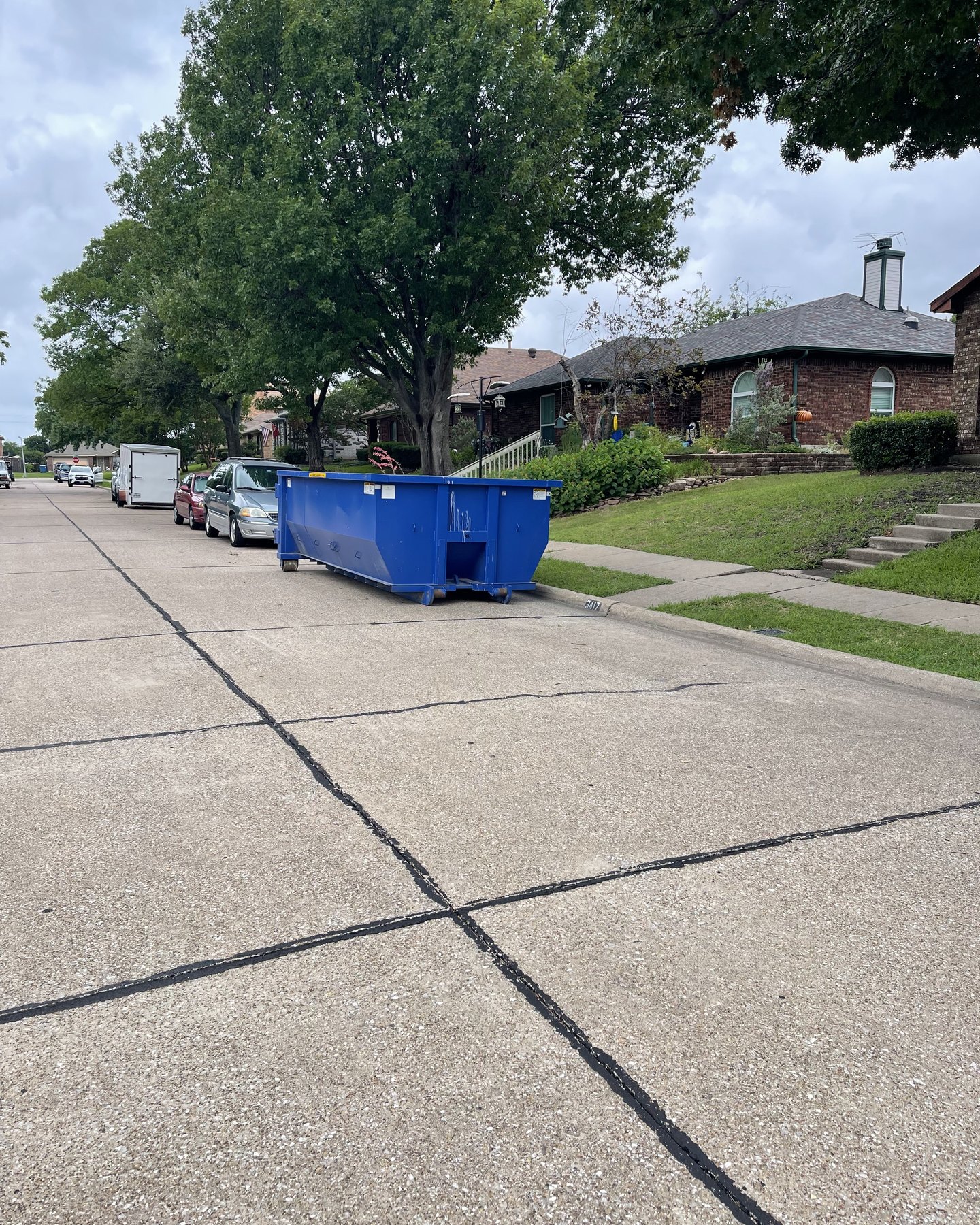 Roll-off dumpster placed curbside on a neighborhood street