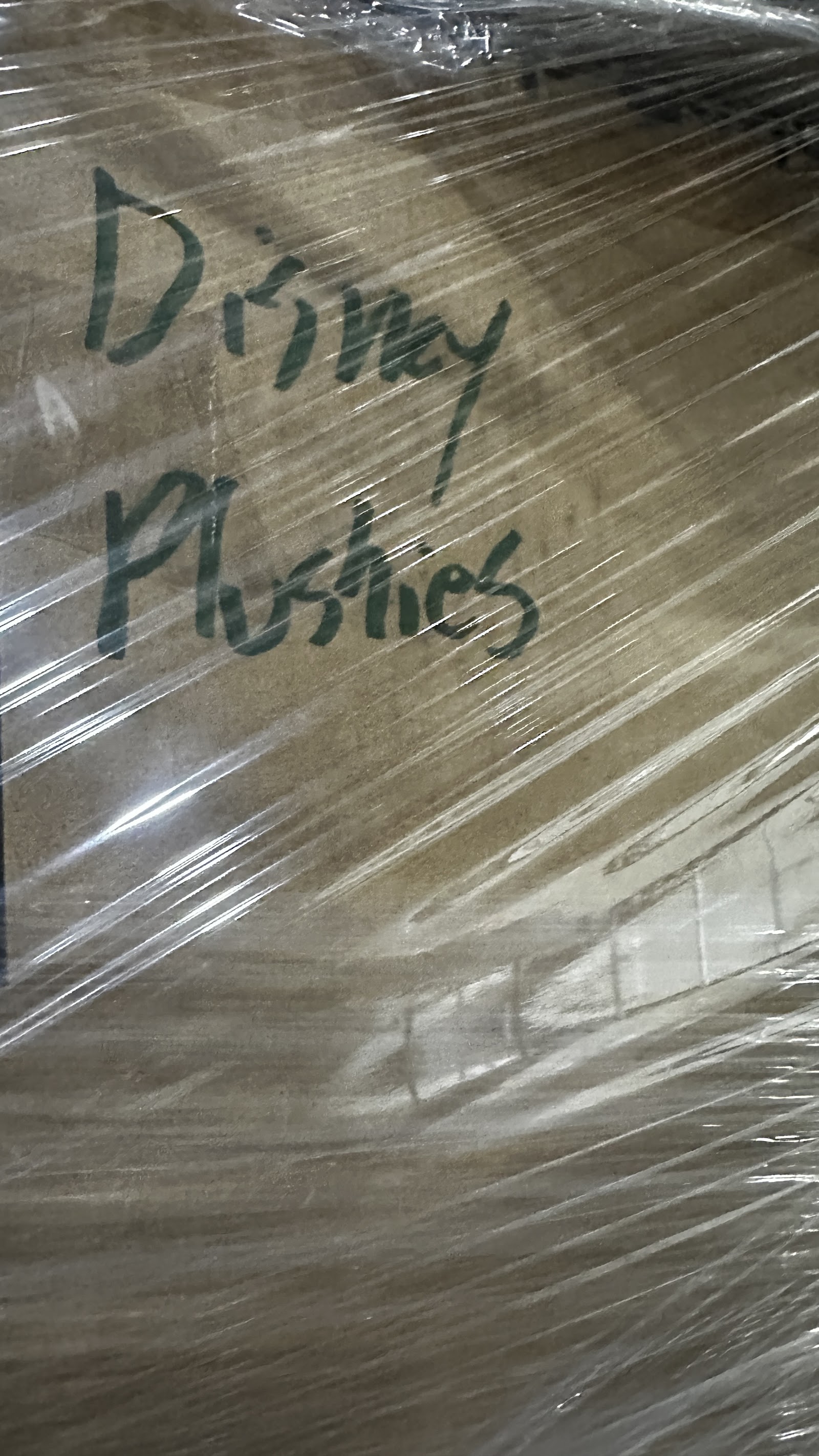 Sealed cardboard box of assorted Disney character merchandise from a private estate collection, spanning the 1970s through early 2000s
