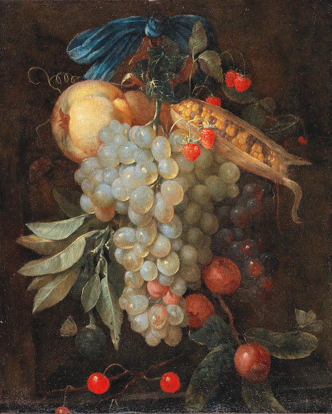 A hanging bouquet of fruit including grapes a pear and corn on the cob with butt