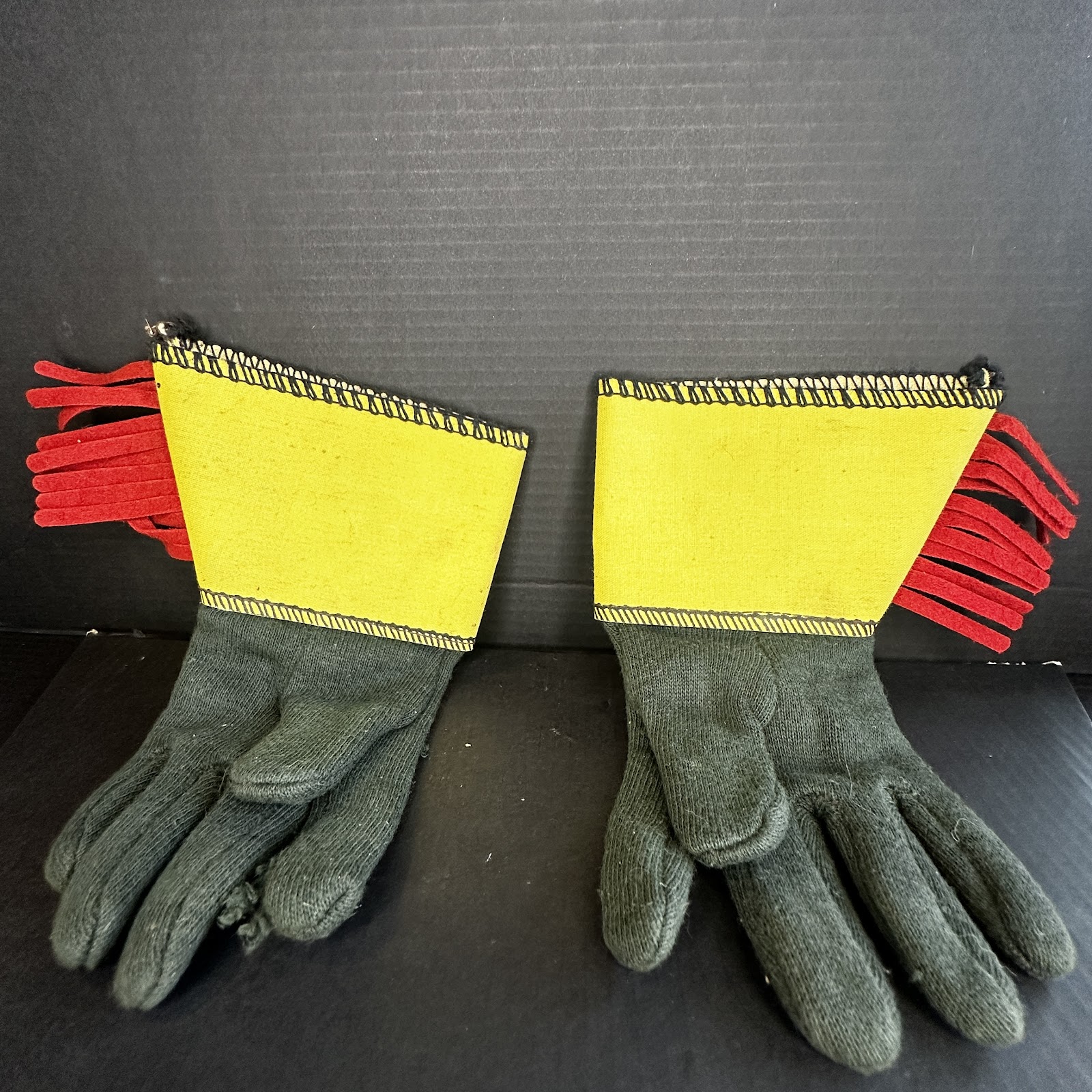 Disney Robin Hood costume gauntlet gloves with dark green knit hands and wide yellow felt cuffs trimmed with black zig-zag stitching and red felt fringe
